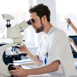 A man using a microscope