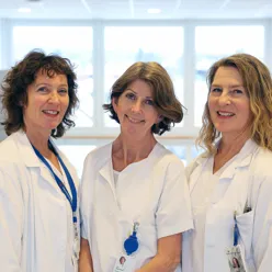 A group of women in white lab coats
