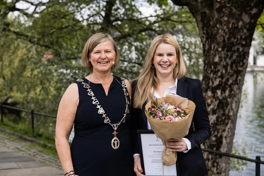 Et par kvinner som holder blomster